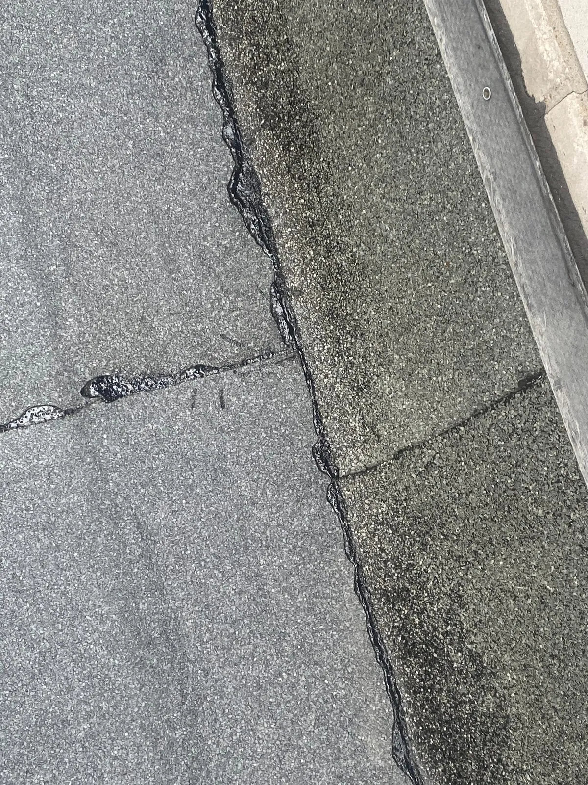 Lähikuva SBS-bitumikermin pintasaumasta ja sirotepinnasta